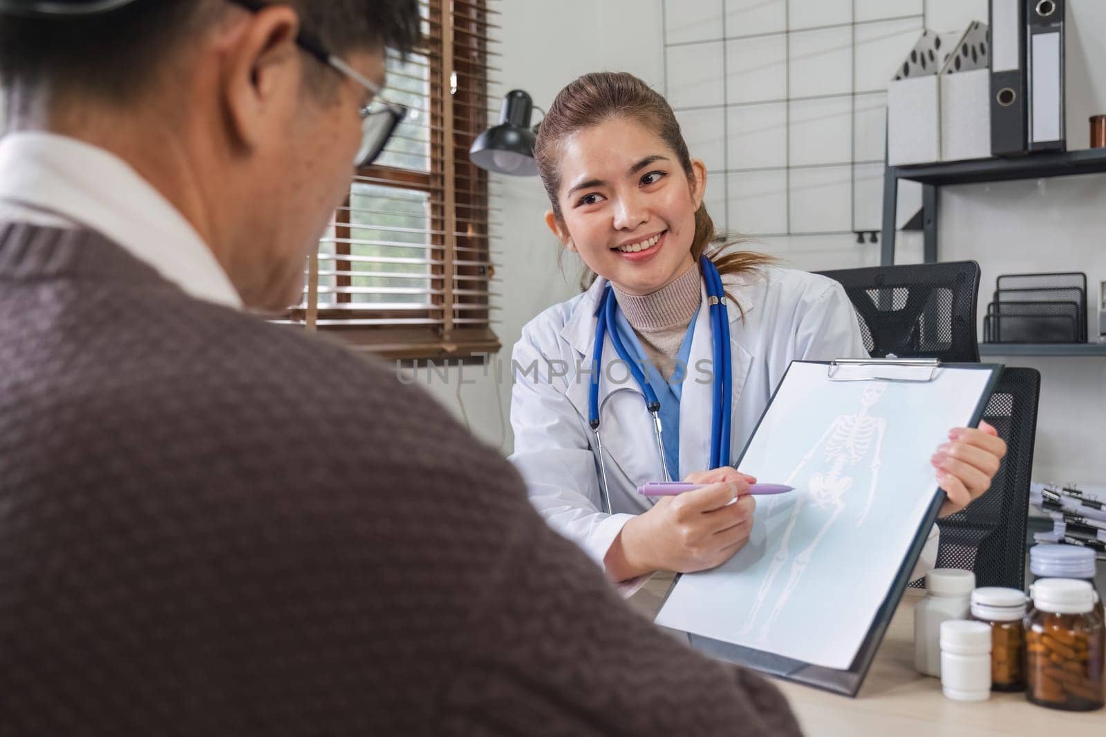 A female doctor is giving advice on diseases and medicine to an elderly male patient. Age 60, concept of health examination and health care.