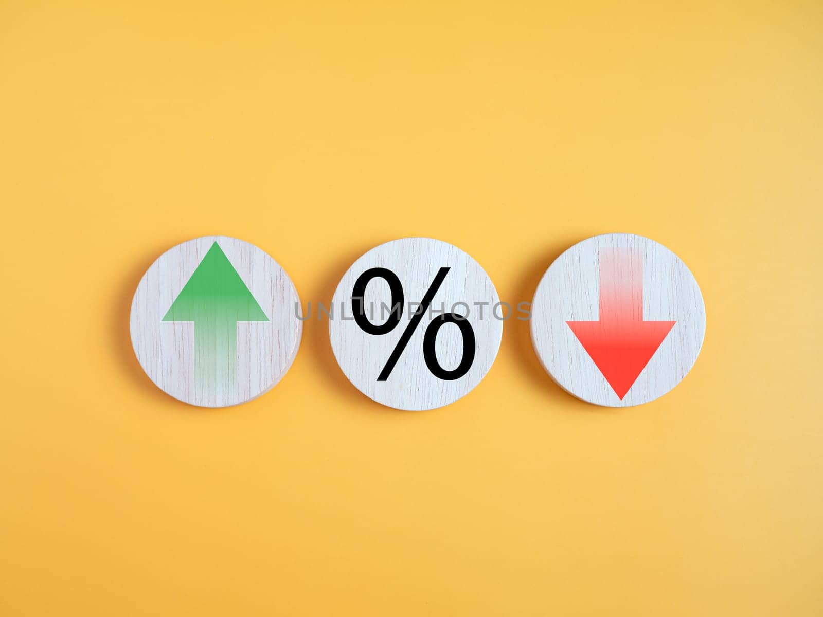 Interest rate financial and mortgage rates concept. Circle wood with icon percentage symbol and arrow up and down direction on yellow background. by Unimages2527