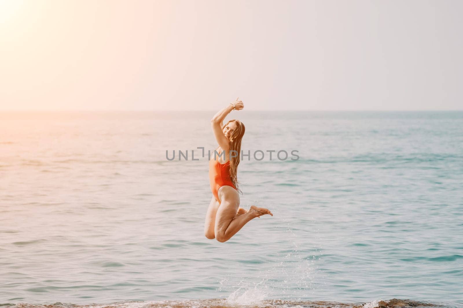 Woman sea yoga. Happy woman meditating in yoga pose on the beach, ocean and rock mountains. Motivation and inspirational fit and exercising. Healthy lifestyle outdoors in nature, fitness concept. by panophotograph