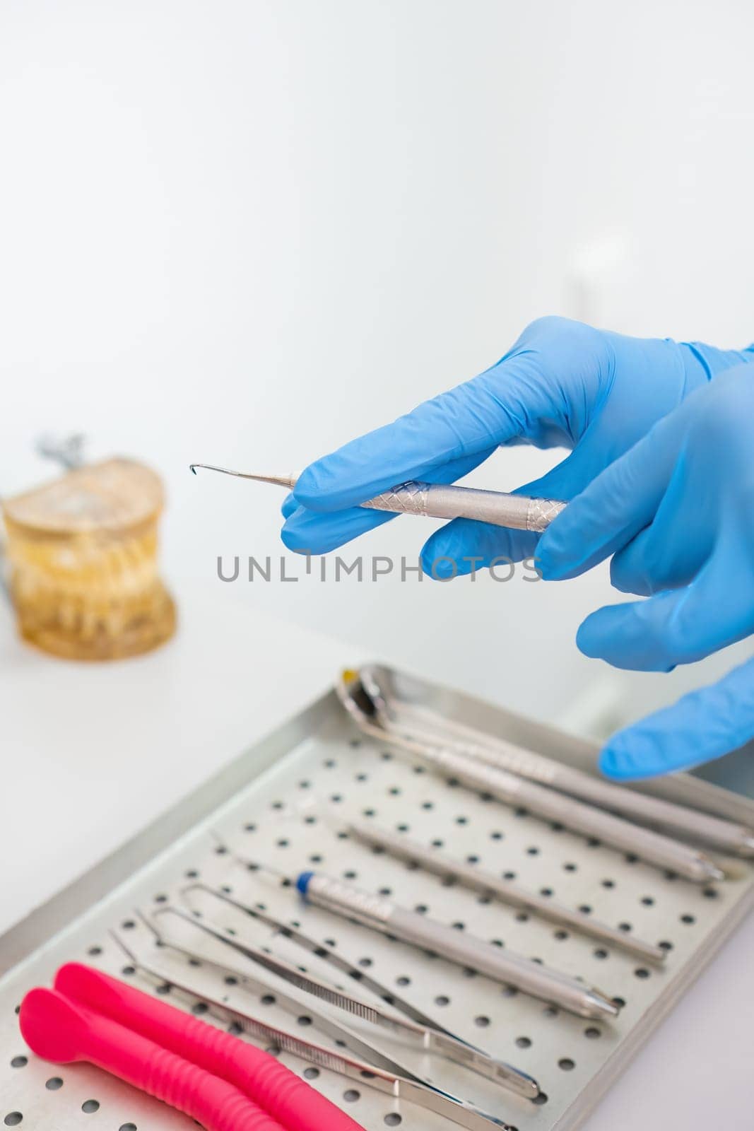 Dentists hands holding dental instruments for teeth treatment by vladimka