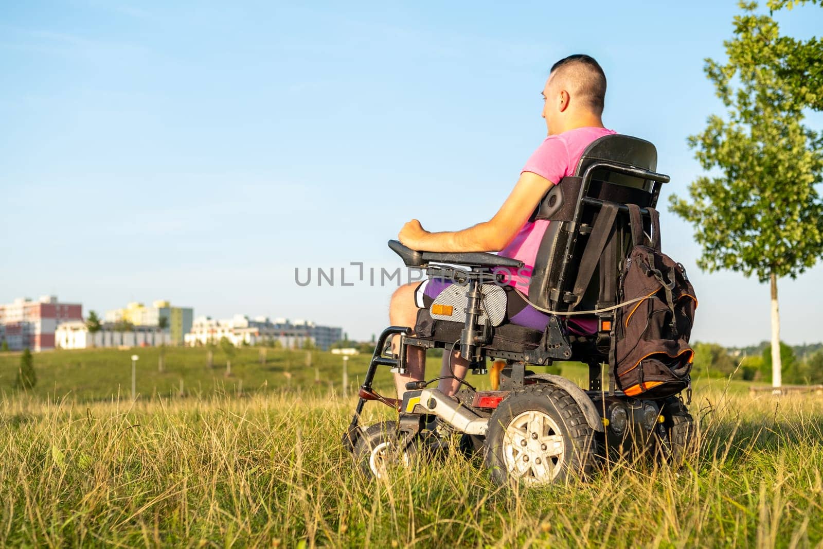 Close up a male in wheelchair during a walk in the park.