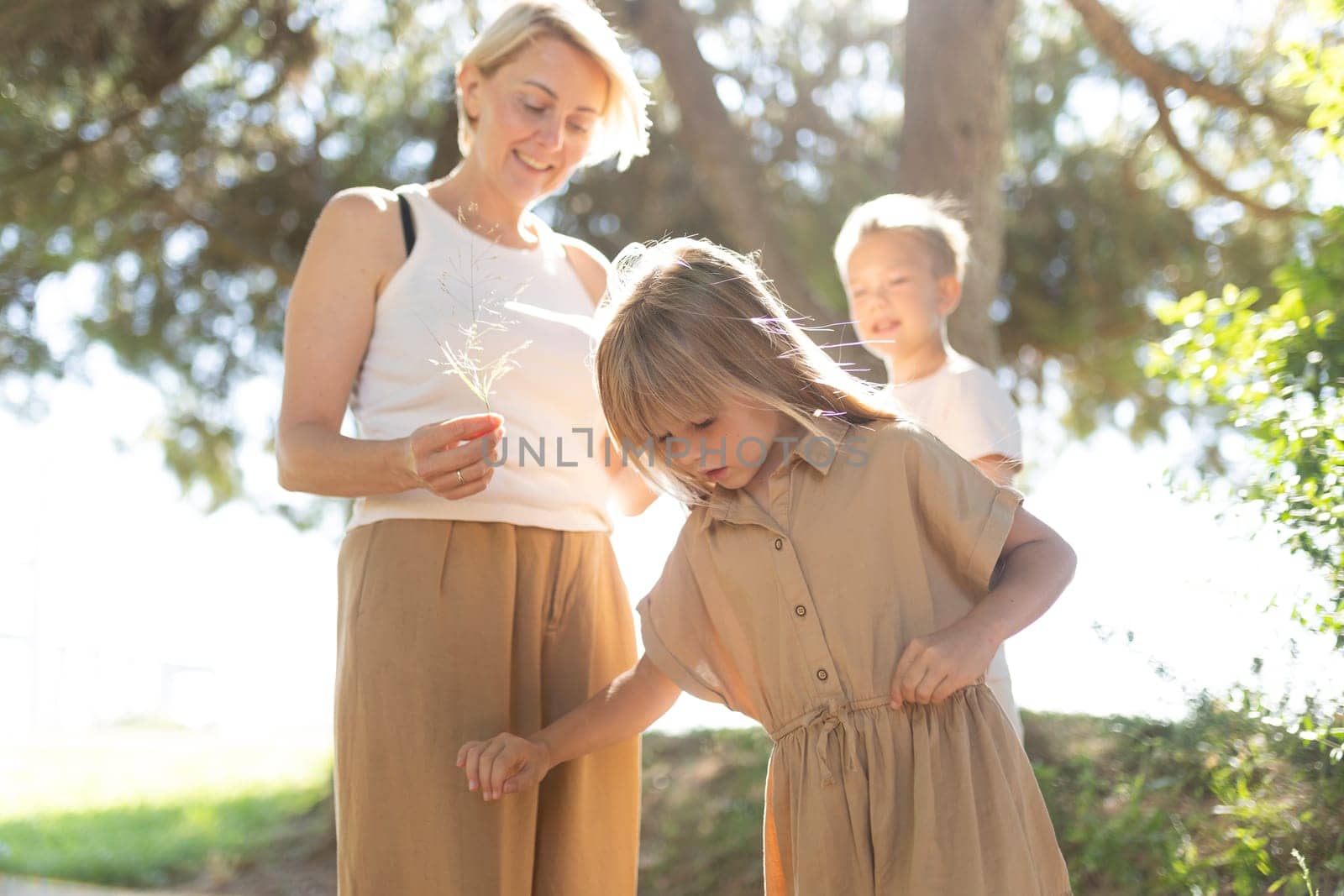 Family exploring outdoors on a sunny day in a park