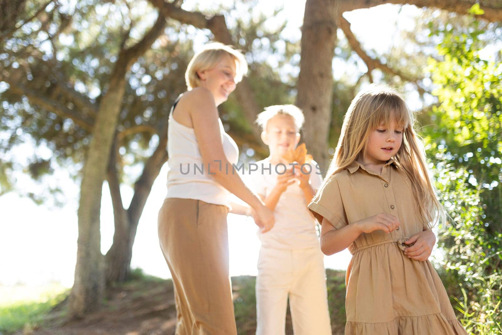 Family spending time outdoors under sunlit trees