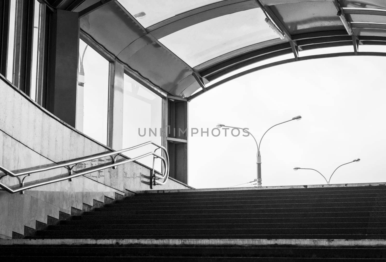 Conceptual, black and white shot of the exit from underground pedestrian crossing