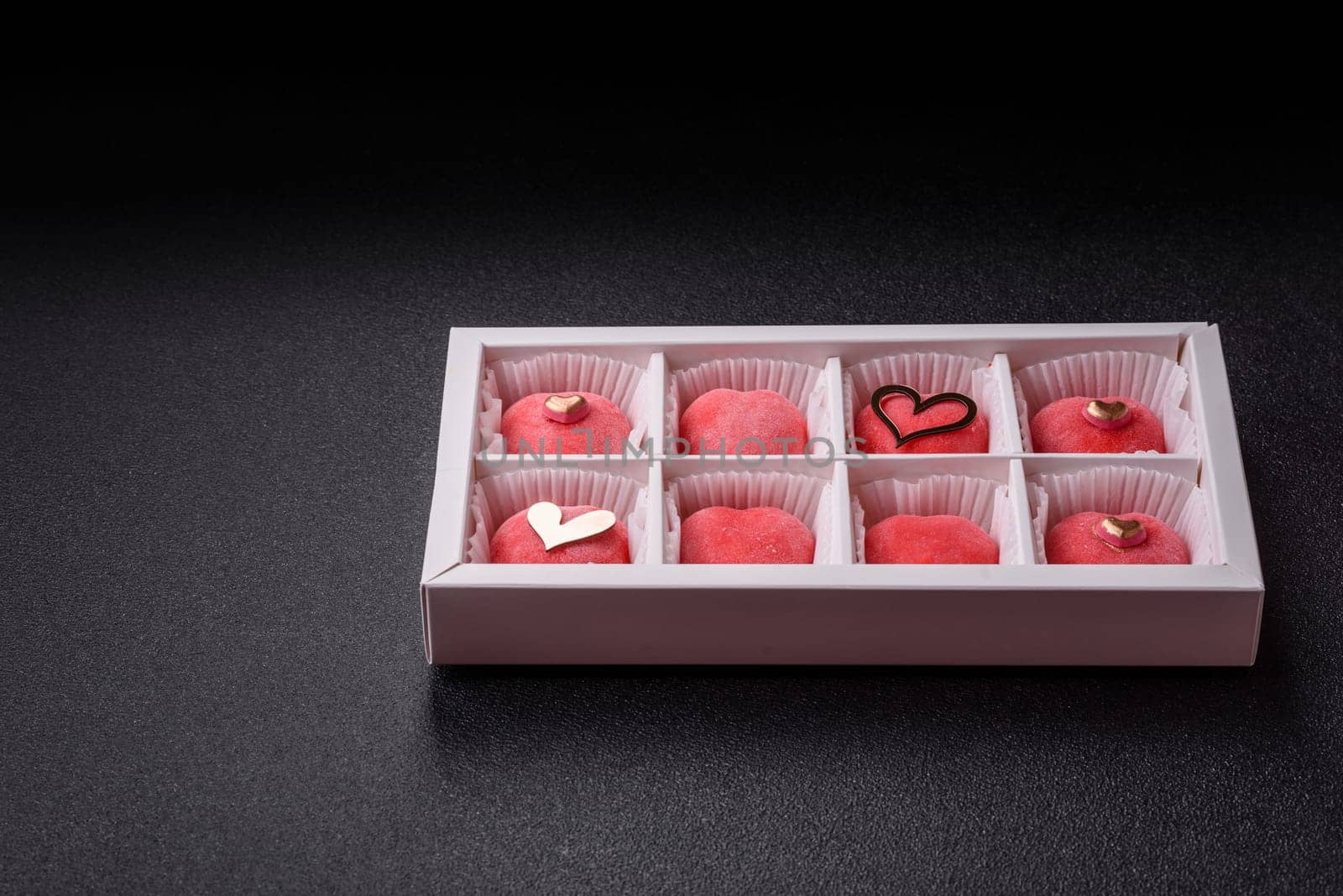 Delicious sweet mochi in the shape of red hearts for the holiday of Valentine's Day