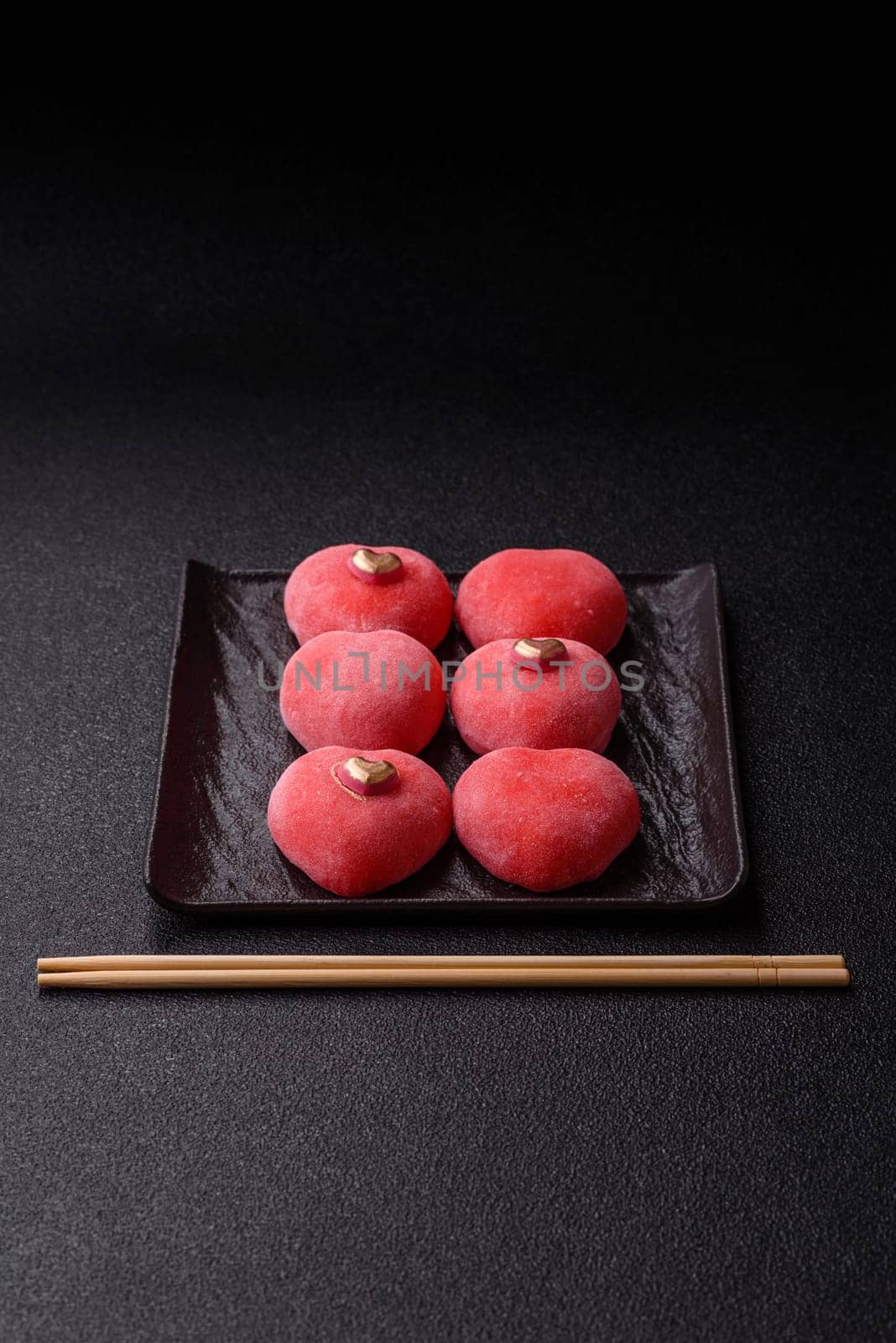 Delicious sweet mochi in the shape of red hearts for the holiday of Valentine's Day
