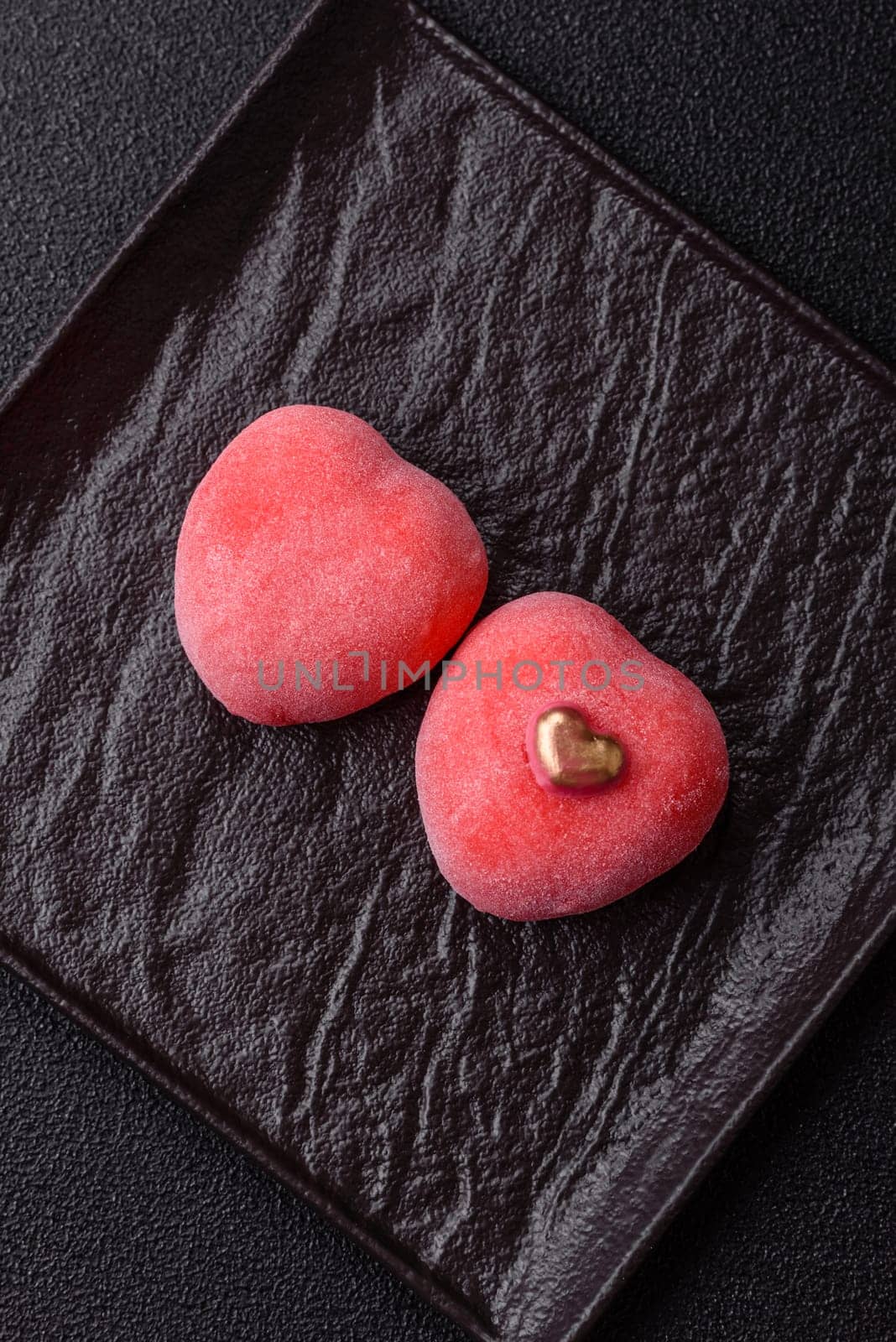 Delicious sweet mochi in the shape of red hearts for the holiday of Valentine's Day