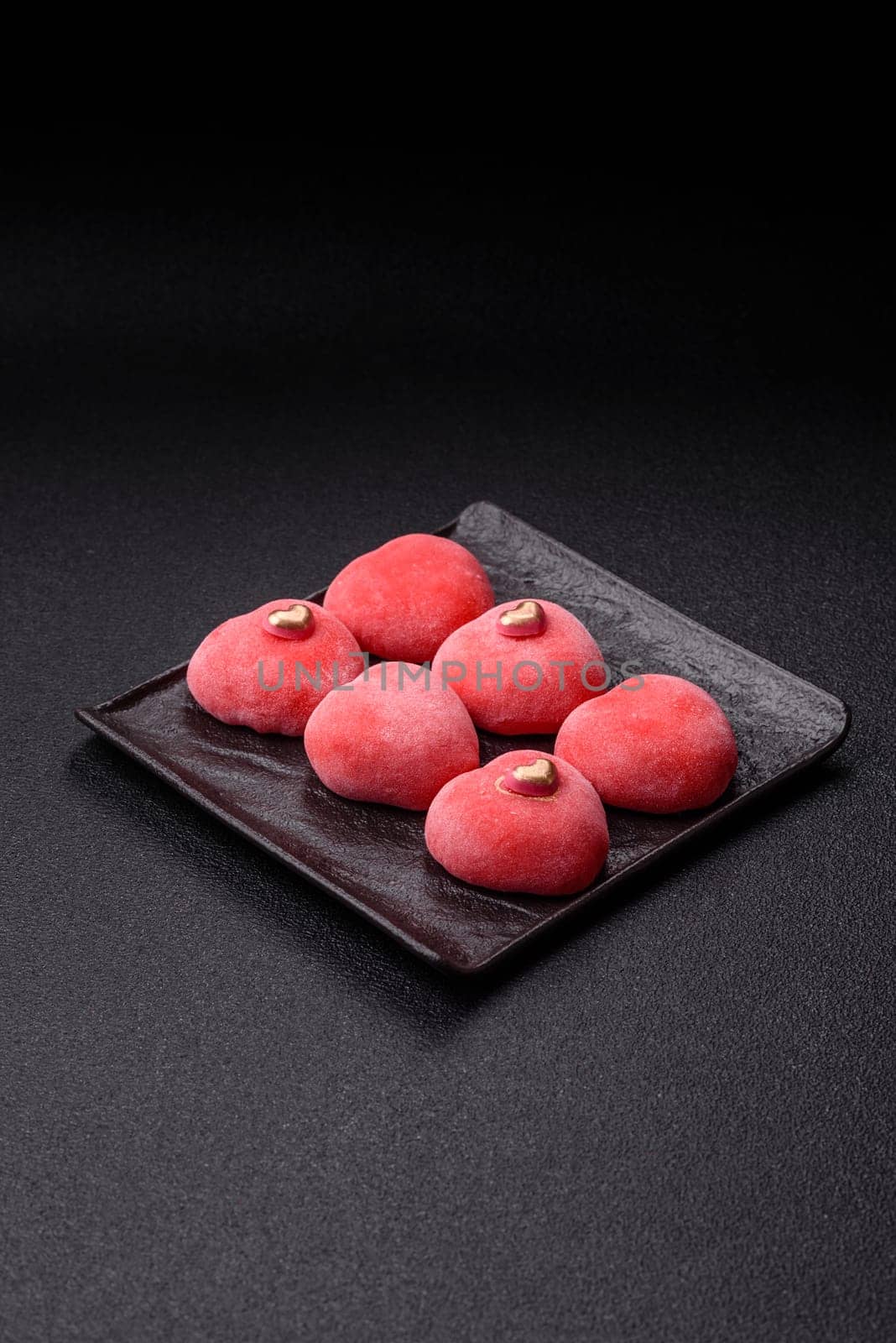 Delicious sweet mochi in the shape of red hearts for the holiday of Valentine's Day