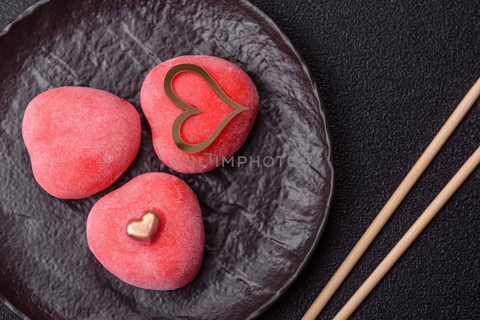 Delicious sweet mochi in the shape of red hearts for the holiday of Valentine's Day