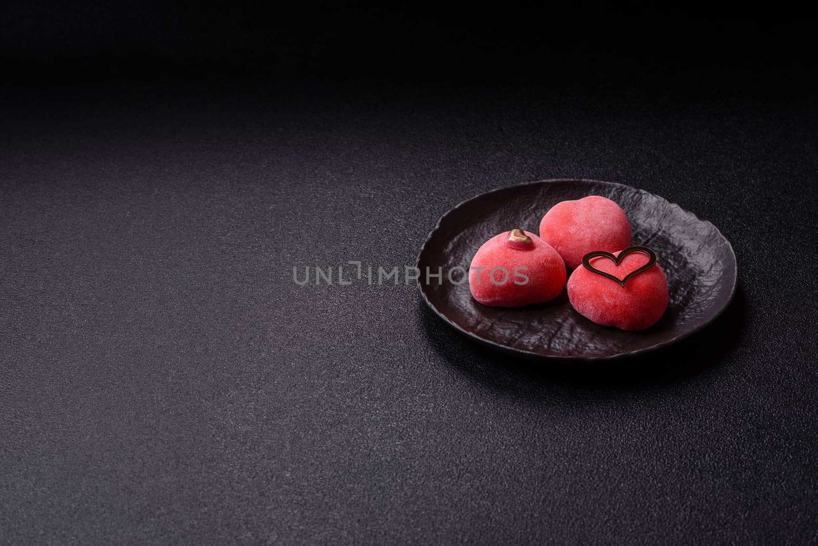 Delicious sweet mochi in the shape of red hearts for the holiday of Valentine's Day