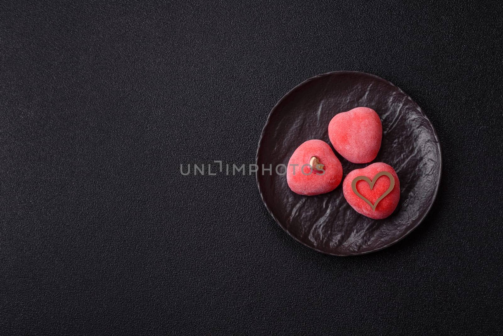 Delicious sweet mochi in the shape of red hearts for the holiday of Valentine's Day