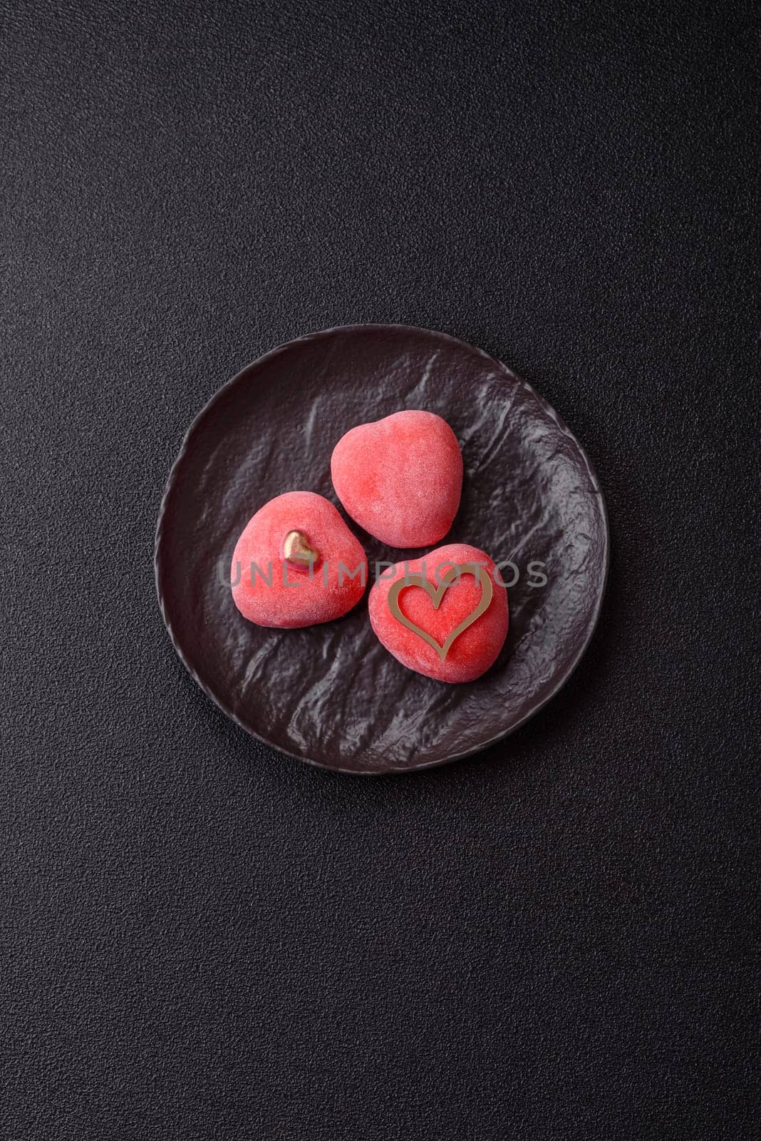 Delicious sweet mochi in the shape of red hearts for the holiday of Valentine's Day