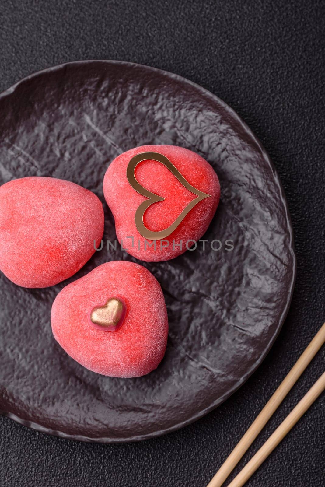 Delicious sweet mochi in the shape of red hearts for the holiday of Valentine's Day