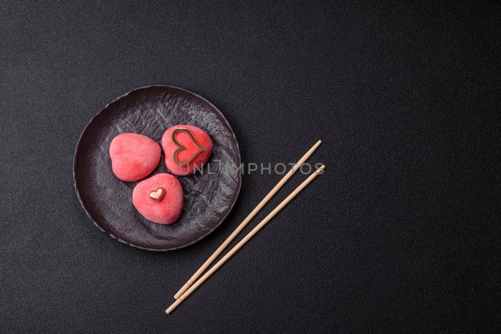 Delicious sweet mochi in the shape of red hearts for the holiday of Valentine's Day
