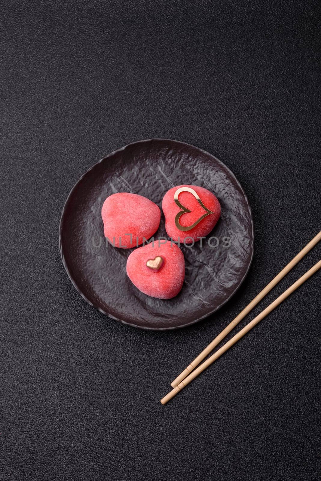 Delicious sweet mochi in the shape of red hearts for the holiday of Valentine's Day