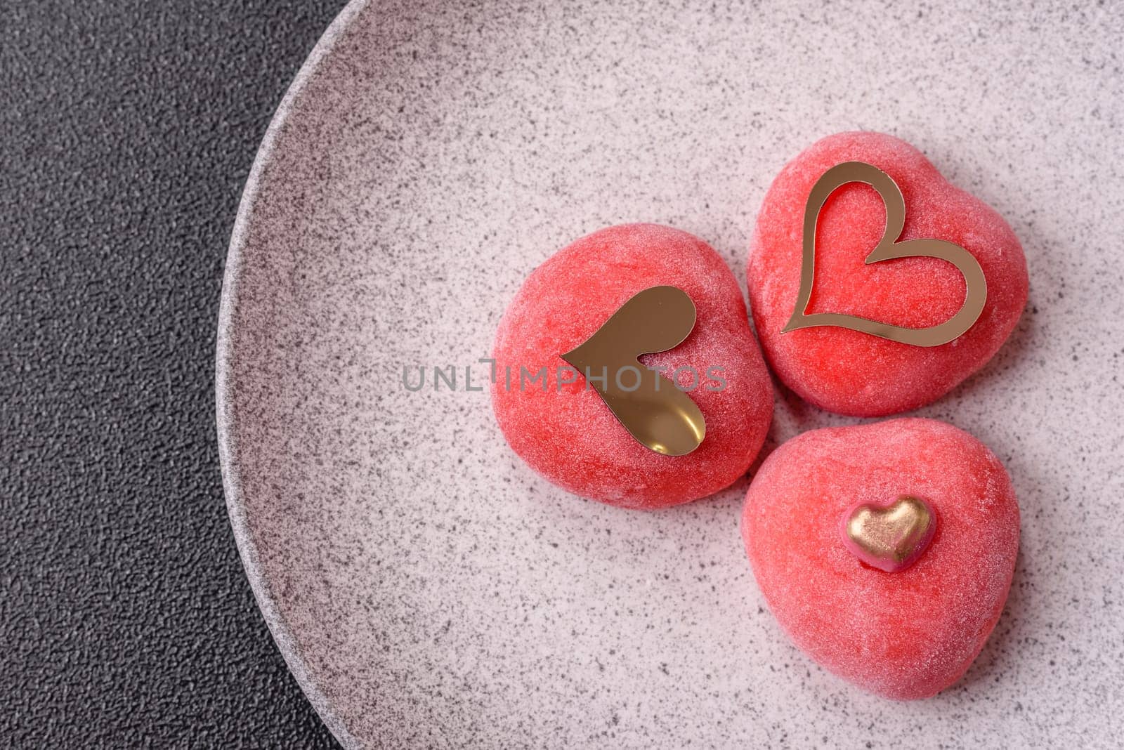 Delicious sweet mochi in the shape of red hearts for the holiday of Valentine's Day