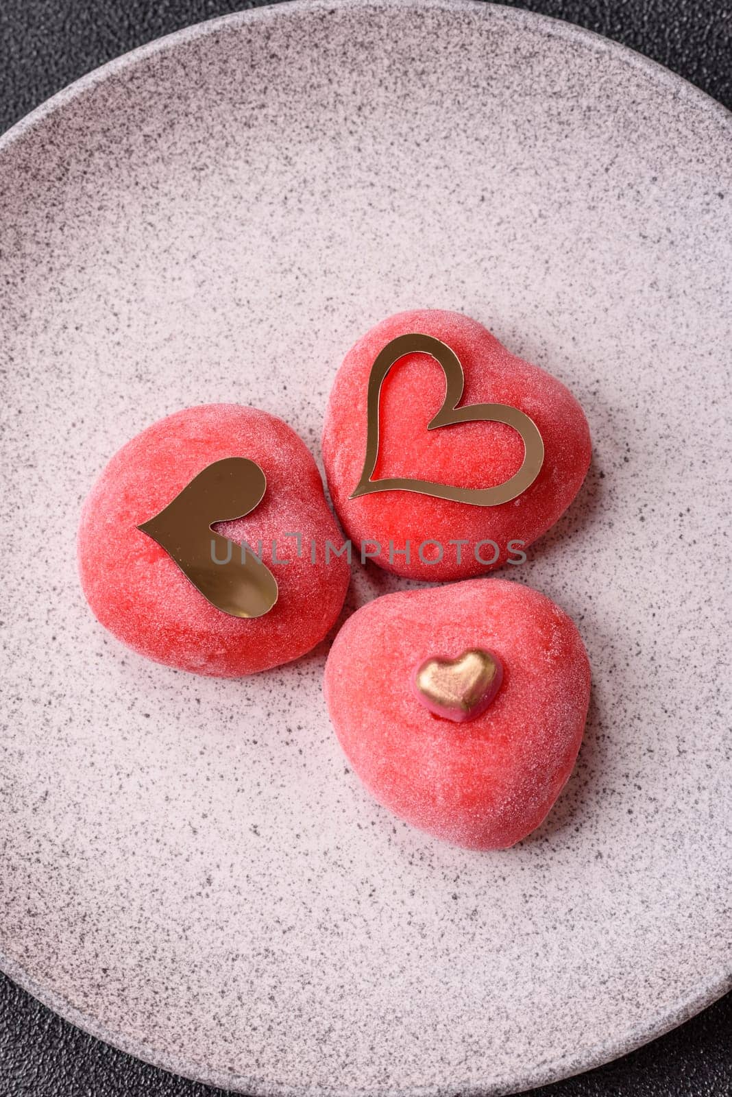 Delicious sweet mochi in the shape of red hearts for the holiday of Valentine's Day