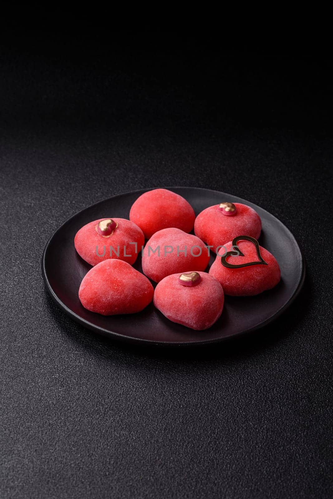 Delicious sweet mochi in the shape of red hearts for the holiday of Valentine's Day