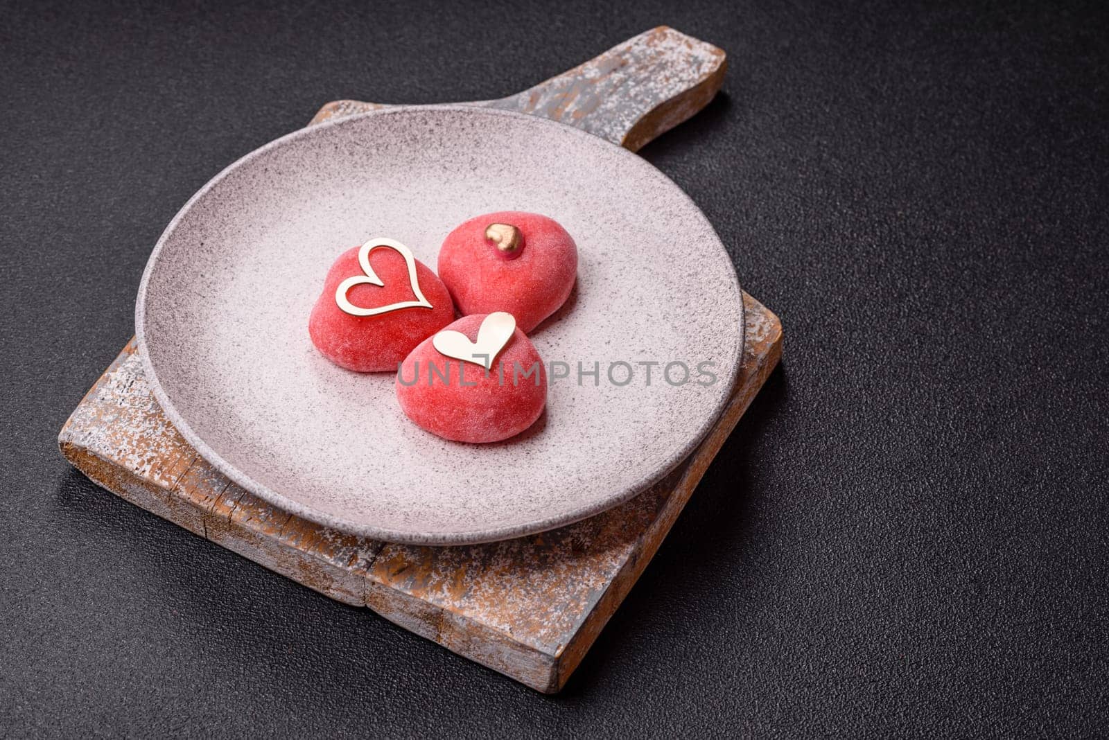 Delicious sweet mochi in the shape of red hearts for the holiday of Valentine's Day