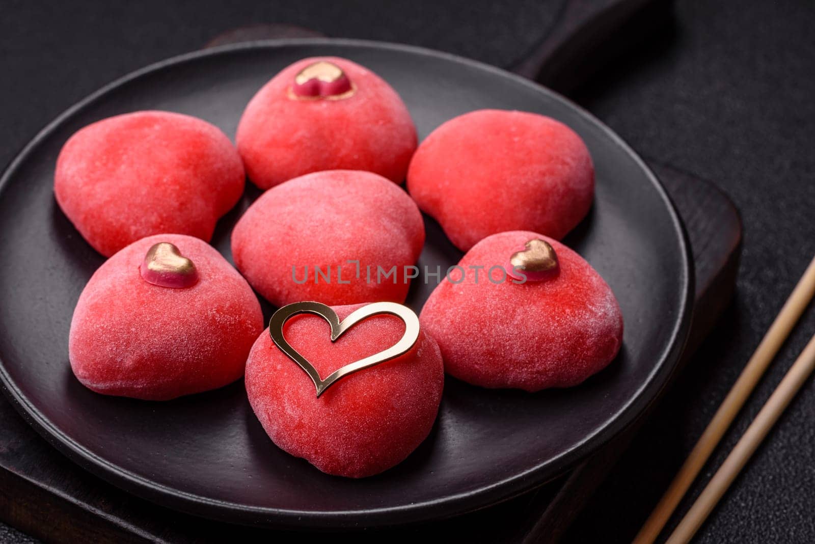 Delicious sweet mochi in the shape of red hearts for the holiday of Valentine's Day