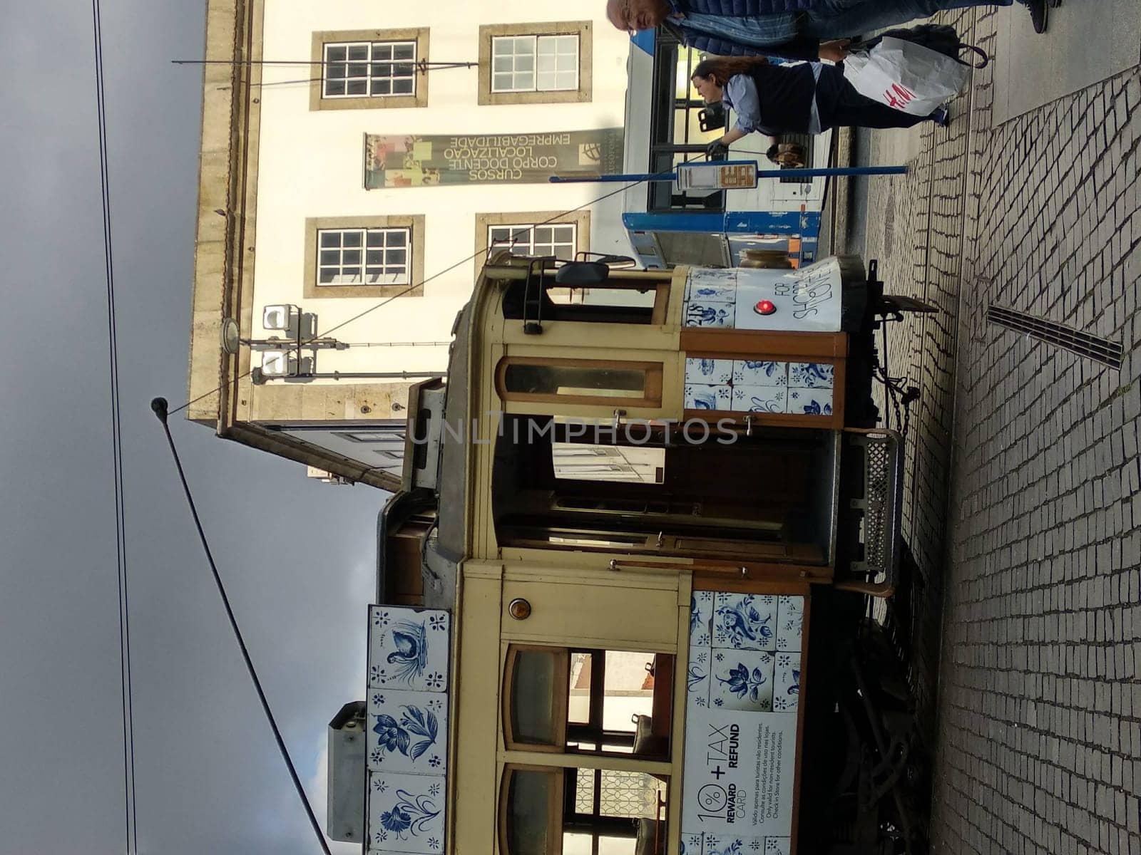 Porto, Europe Portugal -June 7, 2018.yellow tram, residential building with windows . High quality photo