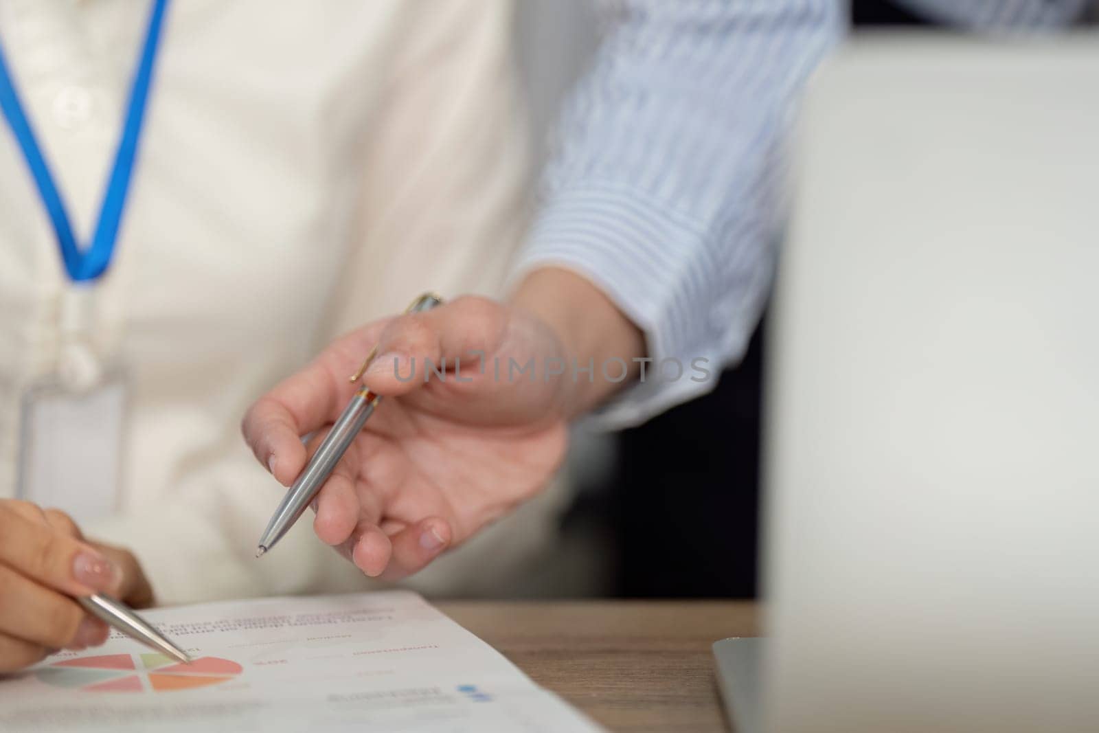 A business team collaborates on strategy reviewing documents and insights to drive success.
