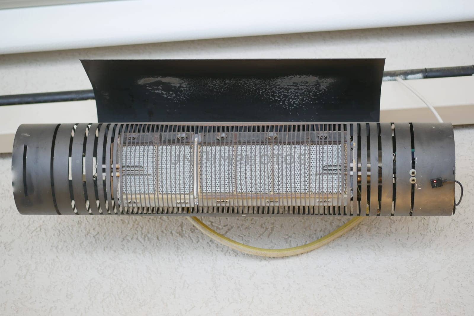 A wall-mounted heating unit provides warmth in a chilly room.