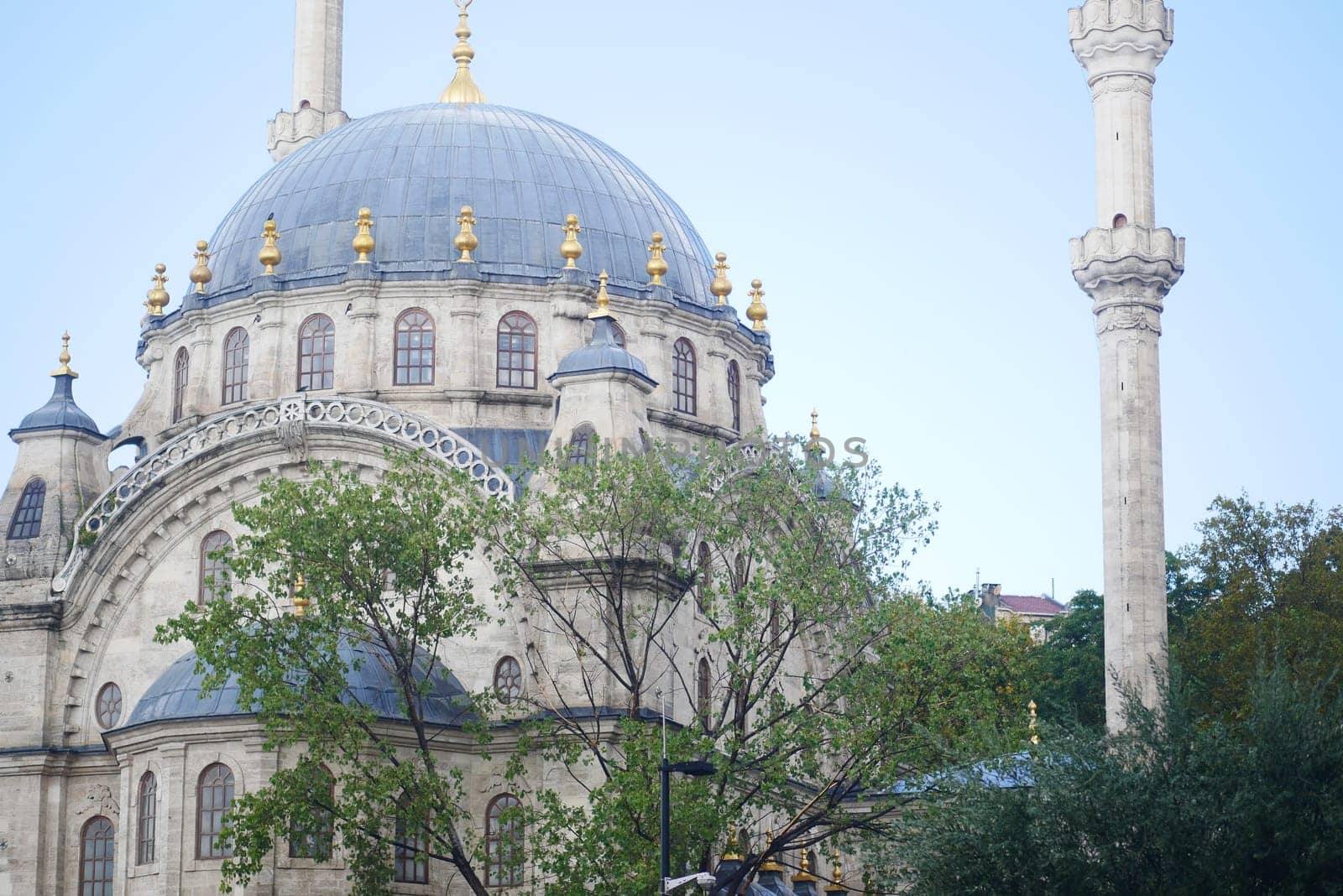 Majestic mosque stands proudly against the clear blue sky in the city.