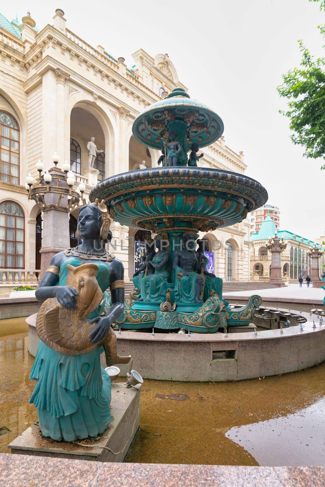 Ganga, Azerbaijan - May 13 2024: Fountain with sculptures, located outside the Ganja State Philharmonic Hall