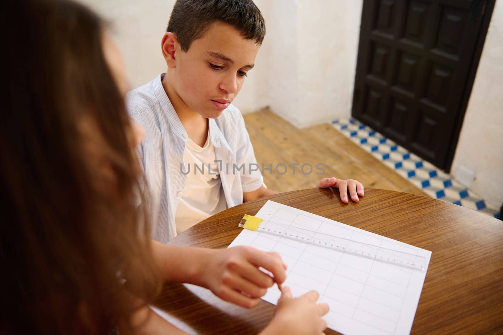 Two children working together on a classroom activity, focusing on teamwork and learning.