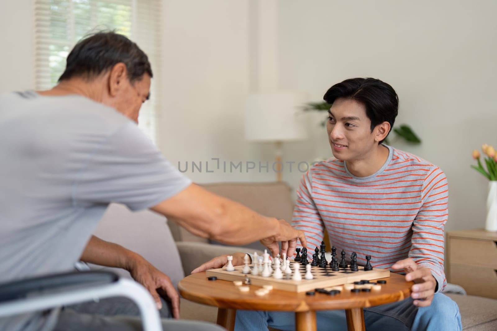A father and son share a strategic chess match, highlighting their bond and the joy of quality time spent together in a warm home environment.
