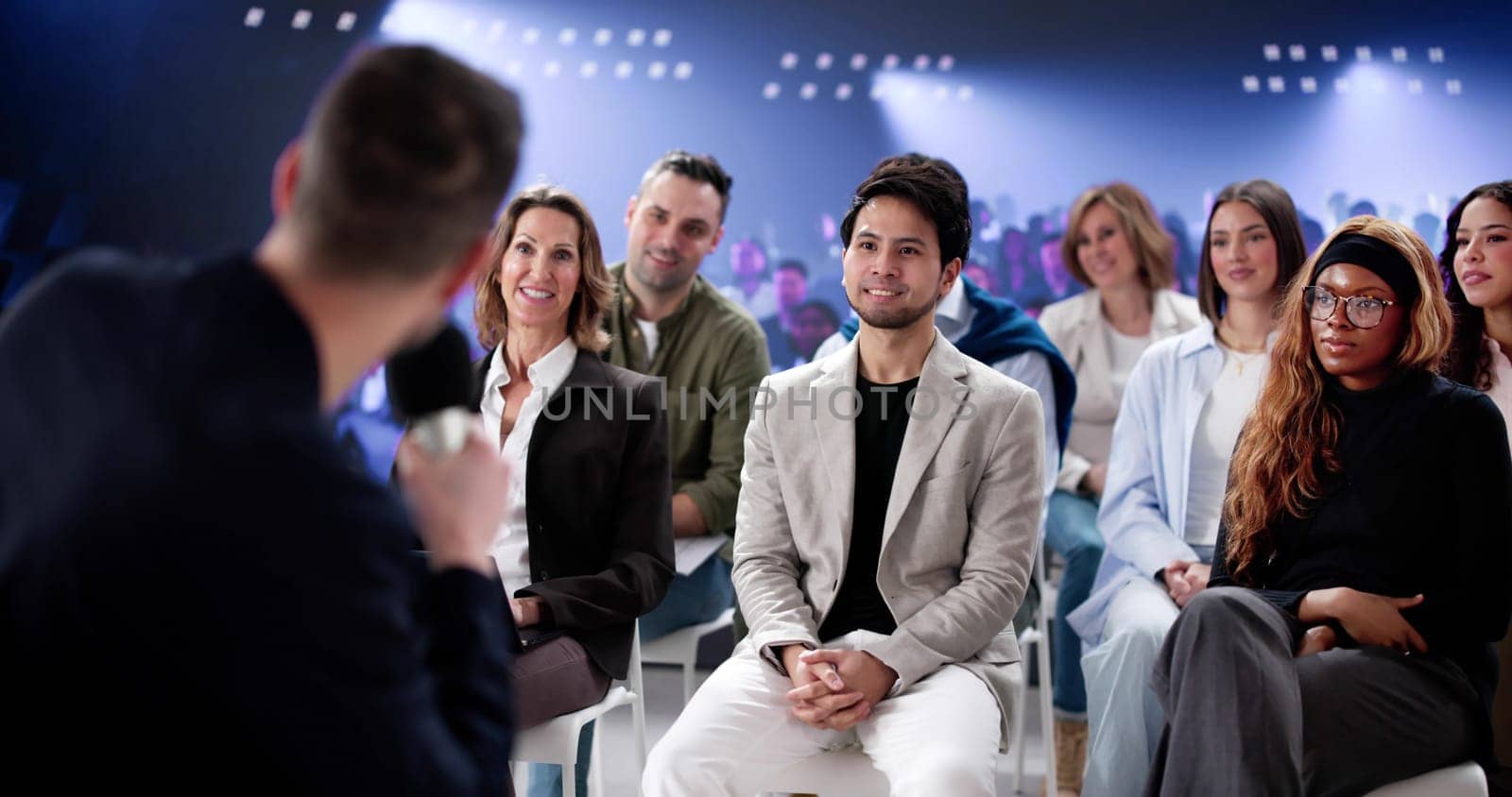 Dynamic Speaker Captivates Audience with Powerful Presentation at Business Conference.