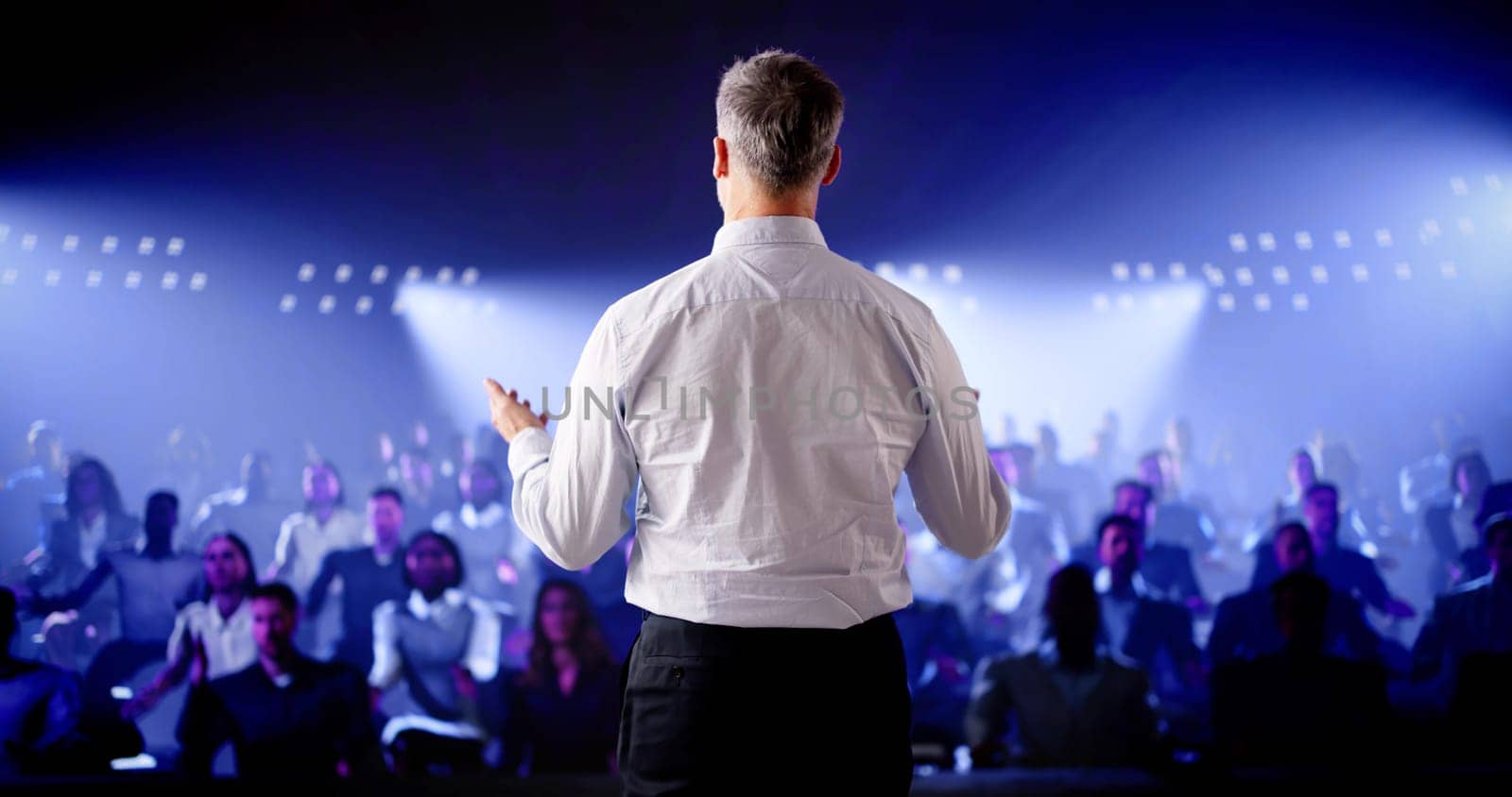 Corporate Speaker Giving Business Speech To Audience At Meeting Or Lecture Event