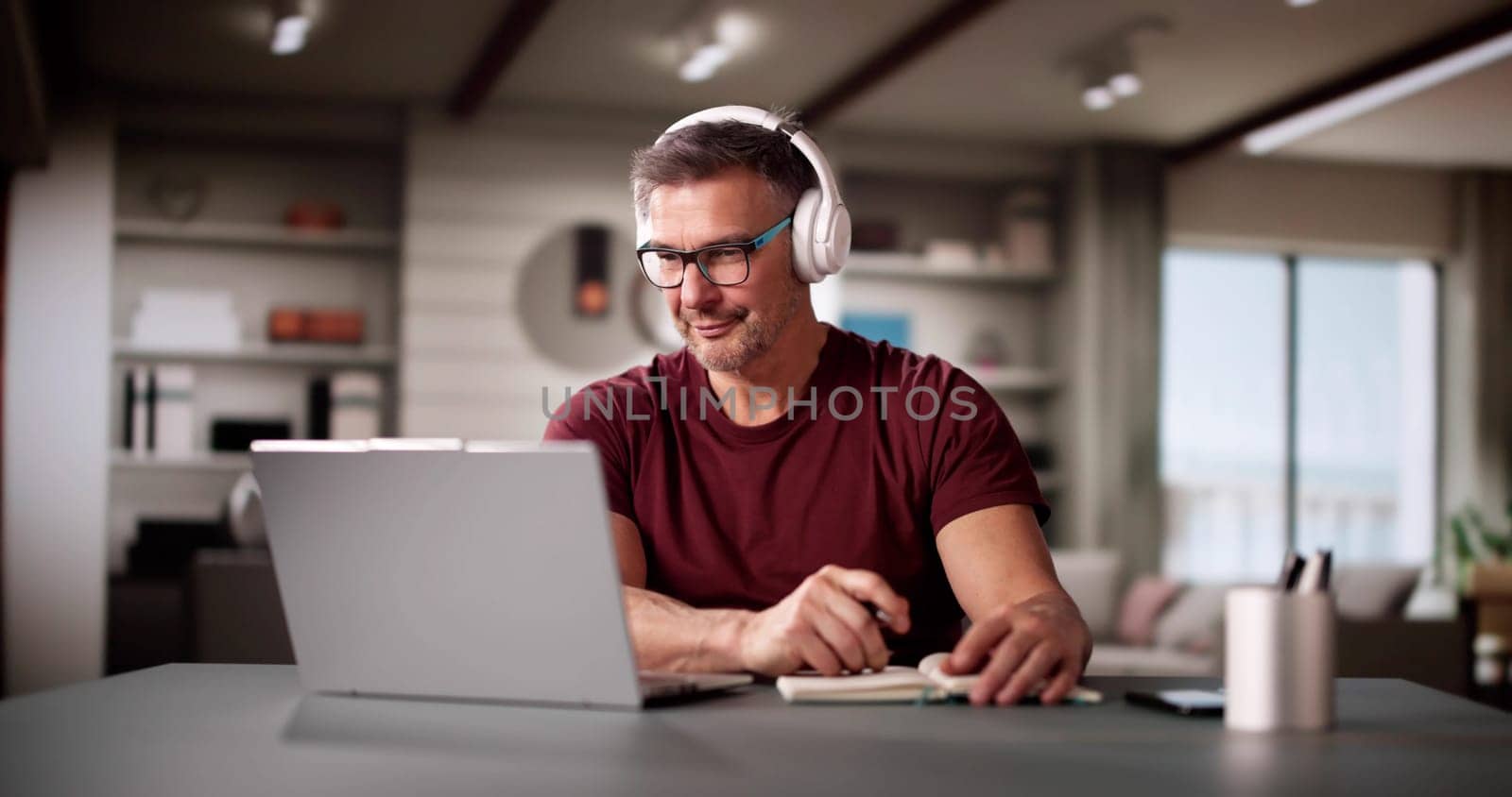 College Teacher At Home Using Laptop Computer