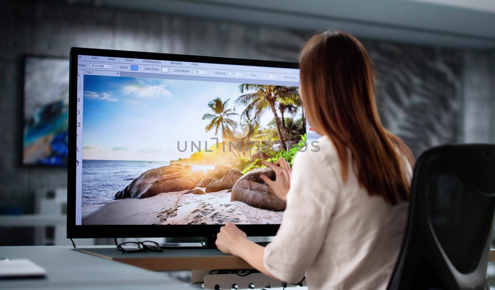 Creative Woman Working at Desk as Graphic Designer in Office.