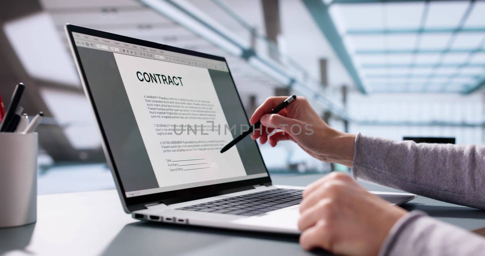 Busy executive insuring trust with legal paperwork on laptop computer.