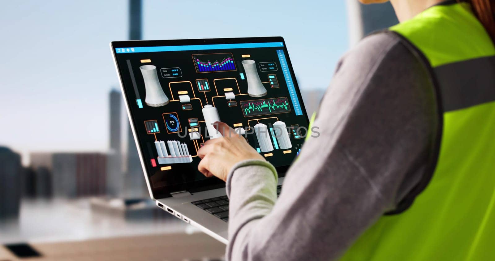 Female Operator Monitoring SCADA System in Power Plant Control Room.