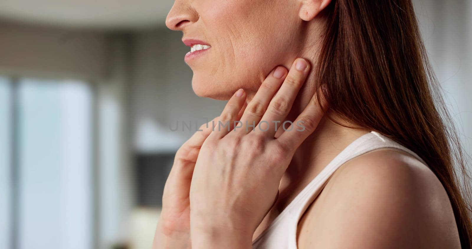 Beautiful young woman experiencing thyroid gland pain and laryngeal cancer