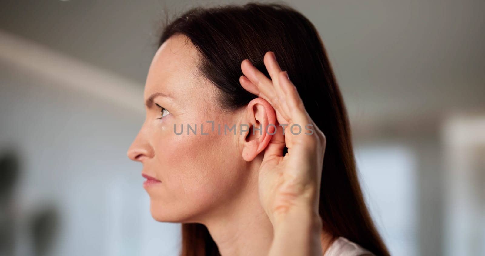 Audiologist aids woman with hearing damage and ear problems.