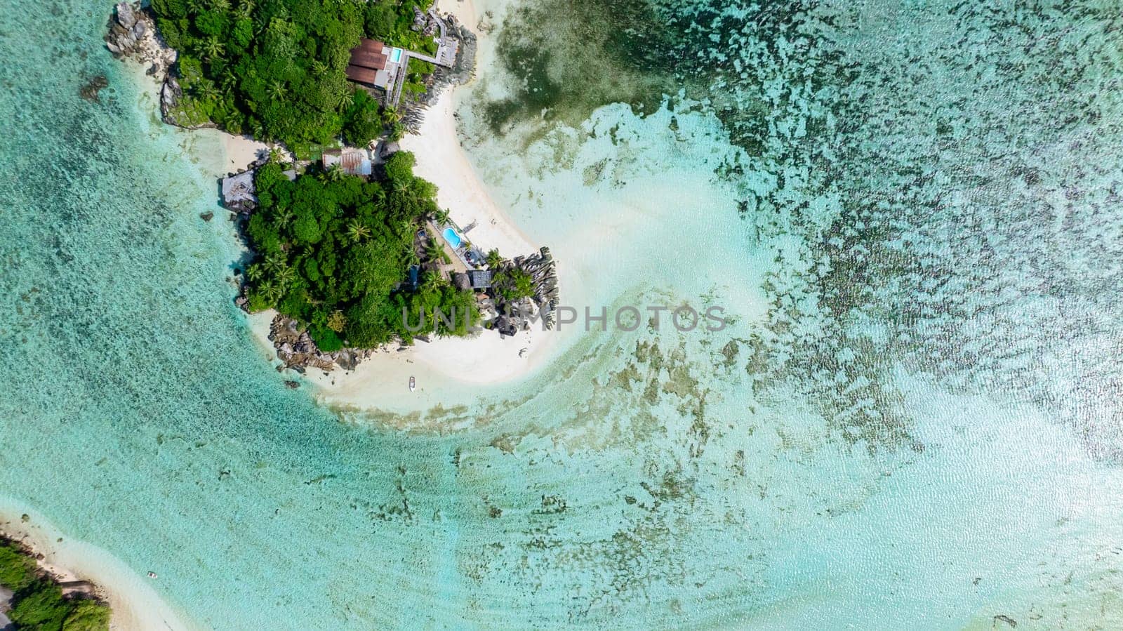 Small island with lush vegetation, white sand beaches, and clear waters. Seychelles, Mahe.