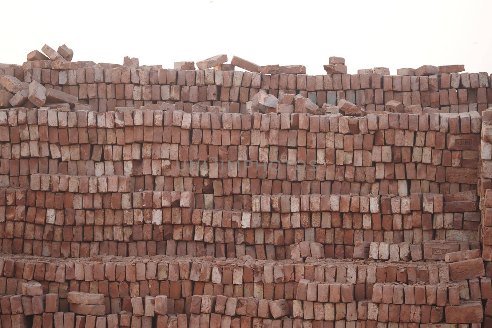 Workers are preparing a supply of bricks for upcoming building projects.