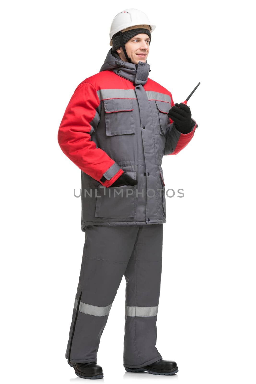 Male in winter workwear, cap and walkie-talkie isolated full-length view