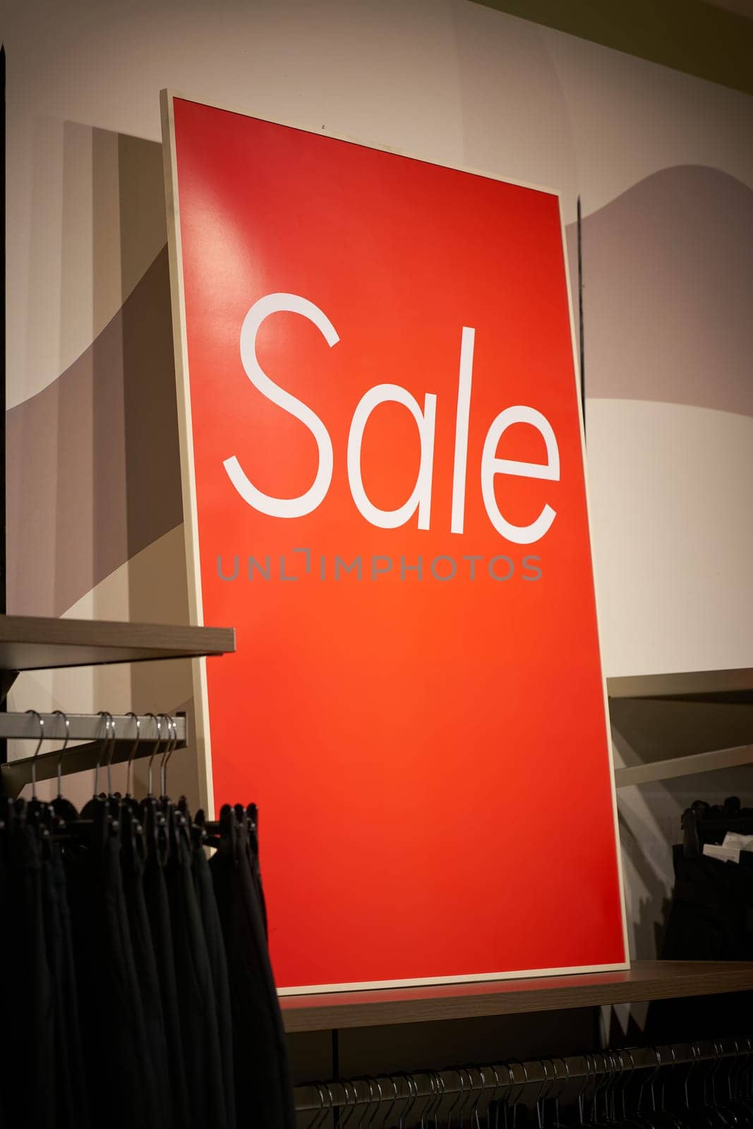 Sign with the inscription Sale to indicate a special offer in a clothing store