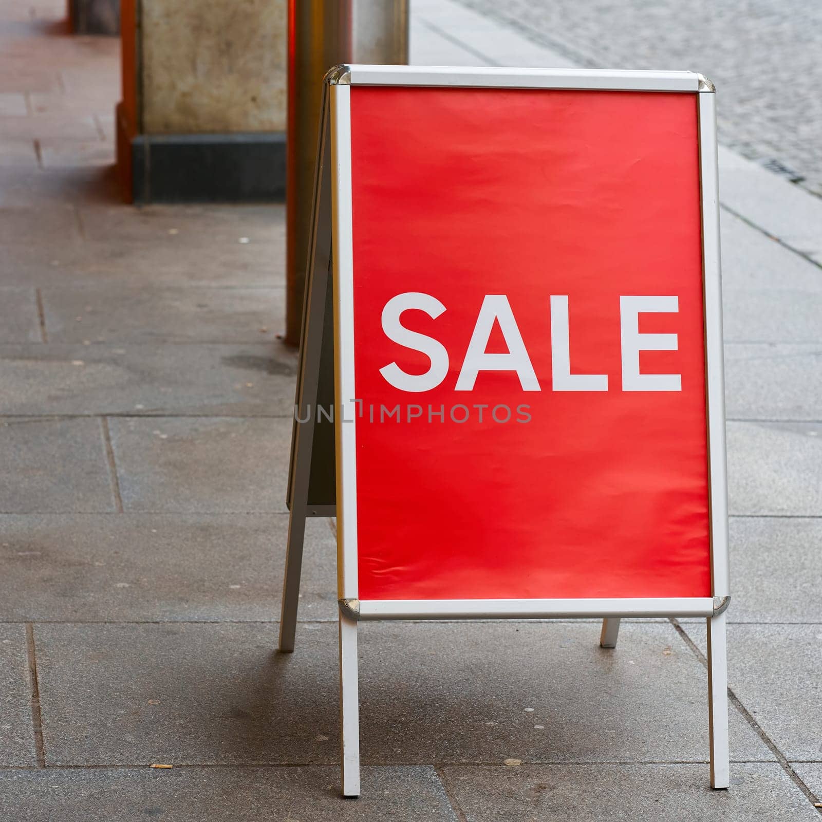 A display in front of a clothing store with the lettering Sale