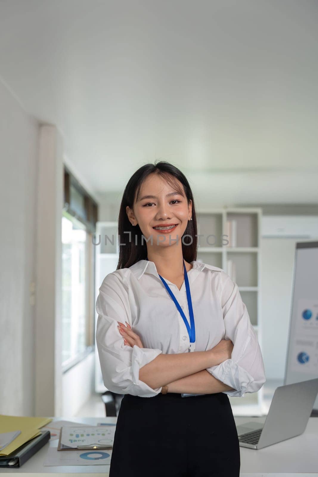 Confident smile businesswoman young asian, happy asian female employee, company sale marketing manager, standing arms crossed in office by nateemee