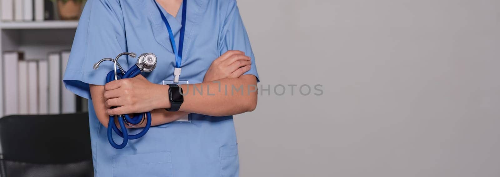 Close up a doctor standing with his arms crossed holding a stethoscope, a doctor from the hospital. Medical staff people. Team of doctor and nurse in hospital. Concept Of Medical.