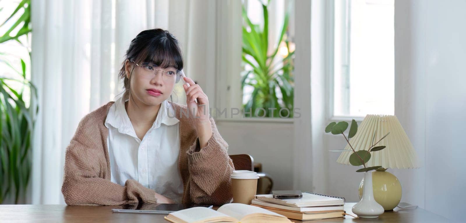 Asian female student studying online, studying on a video call, zoom call, passionate Asian female teacher learning English online with a laptop computer.