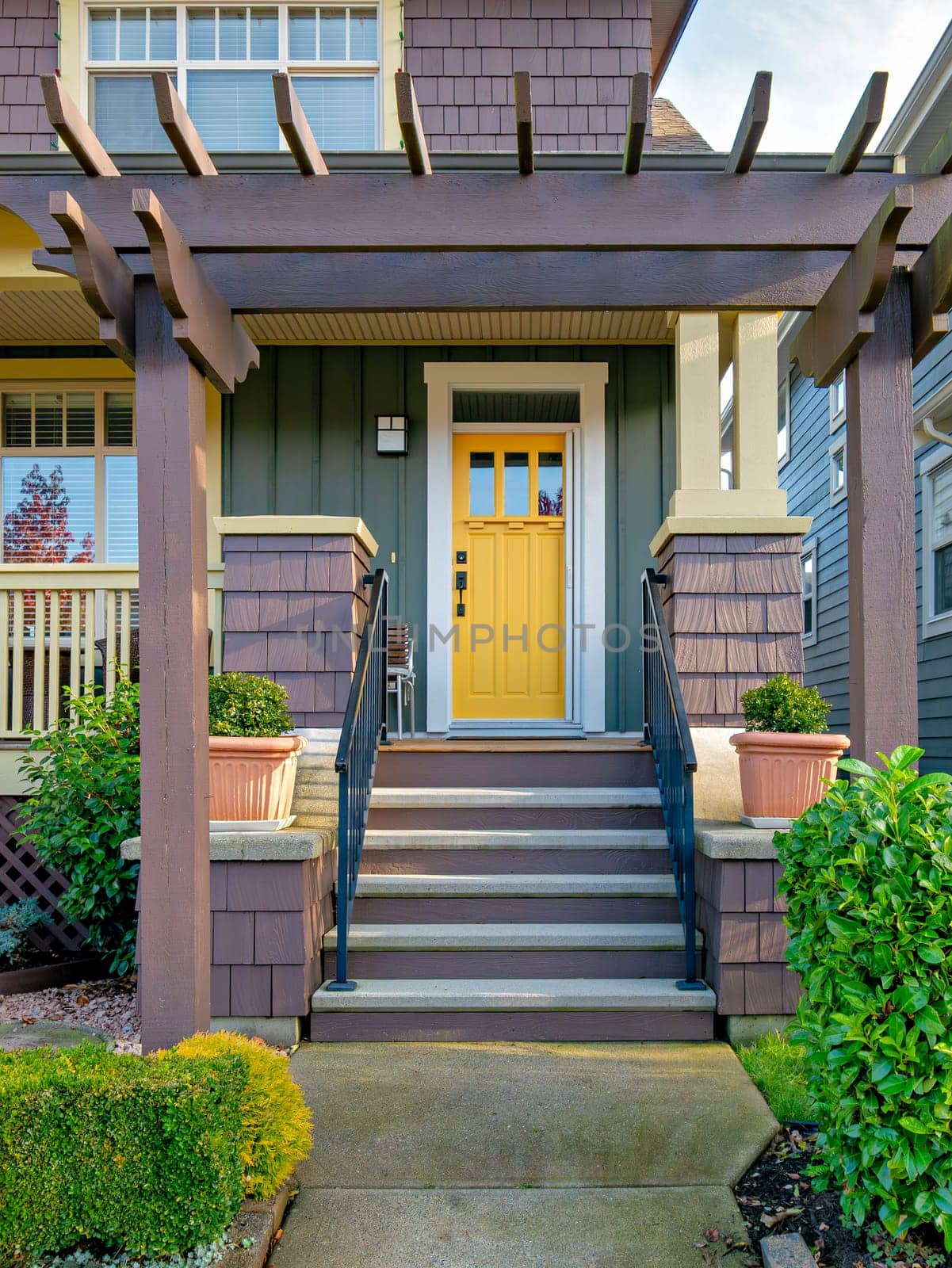 A perfect neighbourhood. Porch and entrance of a nice residential house.