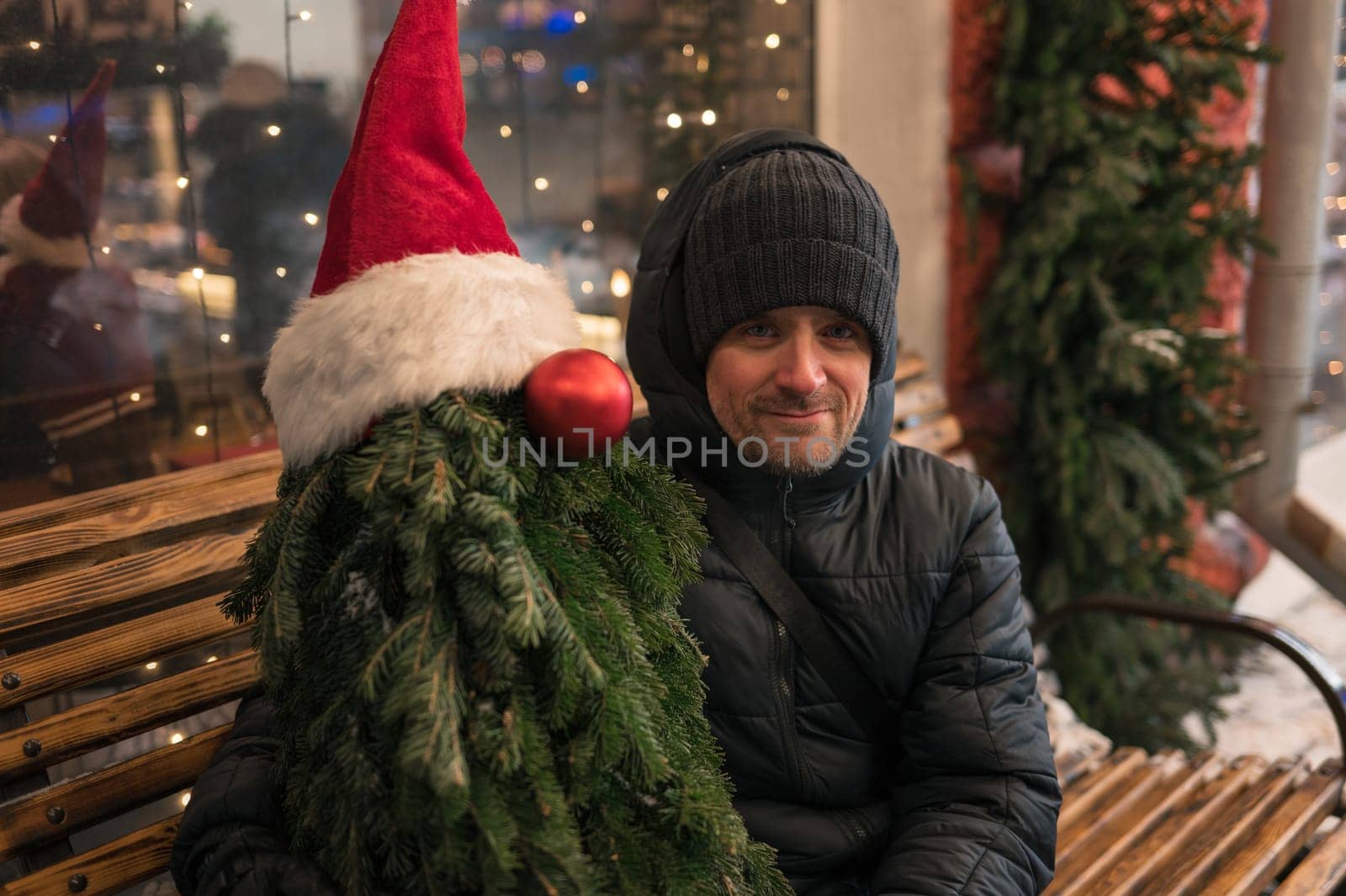 Man with fir tree decorated mannequin. Xmas holidays, New Year or Christmas concept