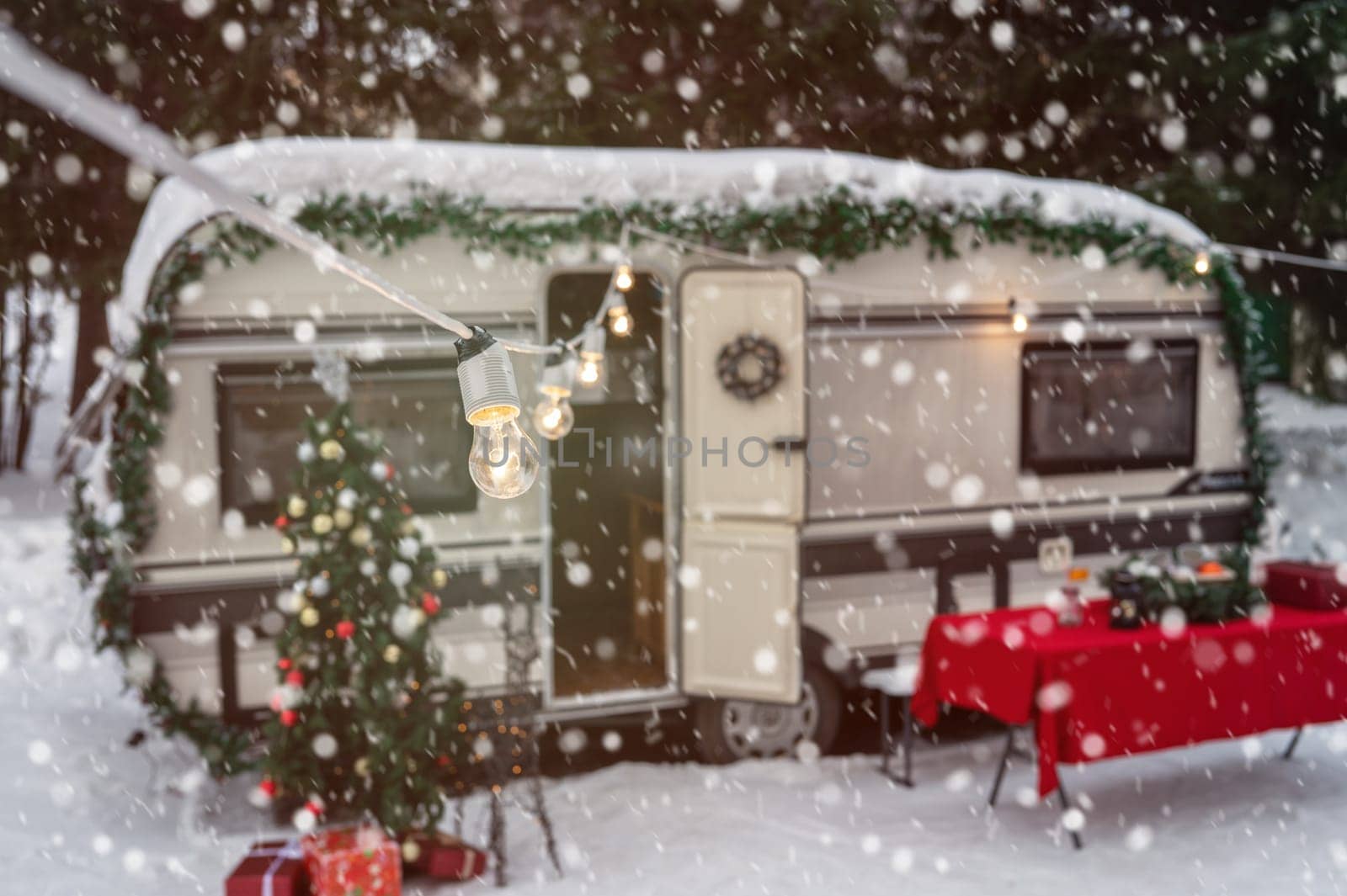 Campervan motorhome in winter camping decorated for Xmas or Happy New Year holiday